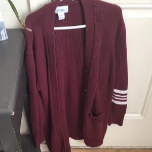 Maroon color jacket with white stripes one one side